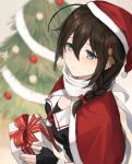  1girl ahoge black_gloves black_hair black_serafuku blue_eyes blurry box braid capelet christmas_tree depth_of_field fingerless_gloves fur-trimmed_capelet fur-trimmed_headwear fur_trim gift gift_box gloves hair_flaps hair_ornament hair_over_shoulder hat highres kantai_collection red_capelet red_headwear remodel_(kantai_collection) santa_hat school_uniform serafuku sha_(isago) shigure_(kantai_collection) single_braid solo upper_body 