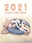  1girl 2021 40hara :3 animal_collar animal_ears animal_print blonde_hair blush_stickers cat_ears cat_tail closed_eyes collar commentary_request cow_print happy_new_year highres kinako_(40hara) long_hair new_year original pet_bed red_collar shirt sleeping solo t-shirt tail 