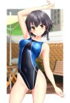  1girl absurdres bangs beach_umbrella bench black_hair black_swimsuit blurry braid brown_eyes chair commentary_request competition_swimsuit cowboy_shot depth_of_field fence girls_und_panzer grin highres looking_at_viewer one-piece_swimsuit pepperoni_(girls_und_panzer) short_hair side_braid smile solo swimsuit takafumi two-tone_background umbrella 