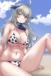  1girl ahoge angoha animal_print beach bikini blue_sky breasts cleavage cloud commentary_request cow_print day headgear highres horizon kantai_collection large_breasts long_hair looking_at_viewer ocean outdoors silver_eyes silver_hair sitting sky solo swimsuit washington_(kantai_collection) white_bikini 