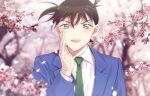  1boy :d bangs blazer blue_jacket blurry blurry_background blush branch brown_hair cherry_blossoms collared_shirt commentary_request falling_petals flower green_neckwear hair_between_eyes hand_up jacket k_(gear_labo) kudou_shin&#039;ichi long_sleeves looking_at_viewer male_focus meitantei_conan necktie open_mouth petals pink_flower school_uniform shirt short_hair smile solo spring_(season) teitan_high_school_uniform tree upper_body white_shirt wind 