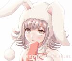  1girl animal_ears animal_hood bangs blush bunny_hood commentary criis-chan danganronpa_(series) danganronpa_2:_goodbye_despair detached_collar english_commentary eyebrows_visible_through_hair flipped_hair hand_up holding hood light_brown_hair looking_at_viewer nanami_chiaki neck_ribbon official_alternate_costume open_mouth pink_eyes playboy_bunny portrait red_ribbon ribbon shiny shiny_hair simple_background solo twitter_username white_background 