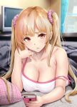  1girl bare_shoulders blonde_hair breasts brown_eyes cellphone cleavage collarbone commentary_request gentsuki highres kotatsu large_breasts long_hair looking_at_viewer original parted_lips phone red_eyes scrunchie smartphone solo strap_slip table television thick_eyebrows twintails 