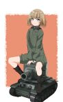  1girl absurdres bangs black_footwear blonde_hair blue_eyes bob_cut boots closed_mouth eyebrows_visible_through_hair girls_und_panzer green_jumpsuit ground_vehicle highres insignia jumpsuit katyusha_(girls_und_panzer) kv-2 long_sleeves looking_away military military_uniform military_vehicle mizukawa_(03_mizu_09) model_tank motor_vehicle orange_background pravda_military_uniform short_hair short_jumpsuit sitting smile solo tank uniform v_arms 