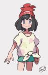  1girl beanie black_hair blush closed_mouth collarbone commentary_request eyebrows_visible_through_hair eyelashes floral_print green_shorts grey_eyes hat hiisu_(s-1104-d) looking_at_viewer pokemon pokemon_(game) pokemon_sm red_headwear selene_(pokemon) shirt short_shorts short_sleeves shorts smile solo tied_shirt 