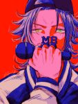  1boy backwards_hat clenched_hand color_contrast covering_own_mouth curtained_hair green_eyes hat heterochromia highres holding holding_microphone hypnosis_mic hypnosis_microphone jacket jewelry looking_at_viewer male_focus medium_hair microphone mole mole_under_eye parted_bangs portrait red_background ring saturated sukajan tareme v-shaped_eyebrows yamada_jiro yellow_eyes zattacafe 