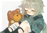  1girl aaoshigatoutoi bandage_on_knee bandaged_leg bandages bandaid bandaid_on_nose crying crying_with_eyes_open girls_frontline grey_hair highres hs2000_(girls_frontline) jacket knees_to_chest long_hair long_sleeves ponytail sitting stuffed_animal stuffed_toy tears teddy_bear yellow_eyes 