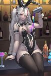  1girl :q absurdres alcohol animal_ears armband azur_lane bar_(place) black_leotard black_thighhighs breasts clothing_cutout cocktail_glass commentary cross cup ddknai drinking_glass eyes_visible_through_hair fake_animal_ears feet_out_of_frame frilled_armband frilled_leotard frills hair_over_one_eye highres iron_cross large_breasts leotard long_hair looking_at_viewer mole mole_on_breast multicolored_hair navel navel_cutout official_alternate_costume playboy_bunny pouring pouring_onto_self prinz_eugen_(azur_lane) prinz_eugen_(between_tipsiness_and_a_wager)_(azur_lane) red_streaks single_hair_streak sitting solo streaked_hair thighhighs tongue tongue_out very_long_hair whiskey white_hair white_wrist_cuffs wrist_cuffs 
