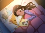  1girl book brown_eyes brown_hair closed_mouth commentary_request holding holding_book idolmaster idolmaster_million_live! kisaragi_ichigo kitazawa_shiho long_hair lying on_side pajamas purple_pajamas reading smile solo under_covers 