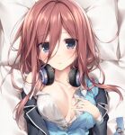  1girl bangs black_cardigan blue_eyes blush breasts brown_hair cardigan collarbone eyebrows_visible_through_hair eyes_visible_through_hair go-toubun_no_hanayome hair_between_eyes hand_on_own_chest headphones headphones_around_neck highres karory large_breasts long_hair nakano_miku open_clothes open_shirt pillow school_uniform shirt solo sweat sweatdrop tag upper_body white_shirt 