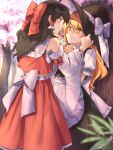  2girls against_tree apron arms_up black_hair black_skirt black_vest blonde_hair blurry blurry_background blurry_foreground blush bow cherry_blossoms cheunes clenched_hands commentary day detached_sleeves eye_contact eyebrows_visible_through_hair hair_between_eyes hair_bow hair_tubes hakurei_reimu hand_on_headwear hat hat_ribbon hat_tug highres kirisame_marisa long_hair looking_at_another multiple_girls nervous outdoors petticoat puffy_short_sleeves puffy_sleeves red_eyes red_skirt red_vest ribbon ribbon-trimmed_sleeves ribbon_trim sarashi shirt short_sleeves sidelocks skirt smile standing touhou tree very_long_hair vest waist_apron white_shirt witch_hat yellow_eyes yuri 