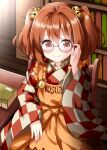  1girl adjusting_eyewear apron bangs bell blush book bookshelf chair character_name checkered checkered_kimono closed_mouth clothes_writing commentary_request cowboy_shot eyebrows_visible_through_hair frilled_apron frills glasses hair_bell hair_between_eyes hair_intakes hair_ornament hand_up highres indoors japanese_clothes kimono library long_sleeves looking_at_viewer medium_hair motoori_kosuzu on_chair orange_apron pink-framed_eyewear red_eyes ruu_(tksymkw) semi-rimless_eyewear sitting smile solo table touhou twintails under-rim_eyewear wide_sleeves wooden_chair 