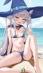  1girl absurdres barefoot beach bikini bikini_pull blue_bikini blue_cape blue_eyes blue_hat blue_sky blush breasts cape clothes_pull commentary_request commission day fang grey_hair hat highres loloco long_hair looking_at_viewer micro_bikini navel ocean open_mouth original outdoors pixiv_commission pointy_ears sitting sky small_breasts smile solo sweat swimsuit twintails witch_hat 