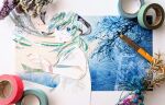  1girl abstract aqua_hair art_tools_in_frame blue_eyes collage commentary_request dress floating_hair flower foreshortening from_behind green_hair hair_ornament hand_up hatsune_miku highres honno_sukoshi_no_sayonara_(vocaloid) long_hair looking_at_viewer looking_back low_twintails masking_tape masking_tape_(medium) multicolored_hair newsprint_texture open_mouth overhead_line photo_(medium) ryono short_sleeves signature solo traditional_media twintails unconventional_media upper_body vocaloid white_dress worried 
