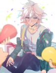  1boy 3others bangs blurry blurry_foreground blush collarbone confetti danganronpa_(series) danganronpa_2:_goodbye_despair food food_on_head gift green_jacket grey_eyes grey_hair grey_shirt hair_between_eyes happy_birthday highres holding jacket knee_up komaeda_nagito long_sleeves looking_at_viewer male_focus messy_hair multiple_others object_on_head off_shoulder open_clothes open_jacket plate print_shirt shirt short_hair sitting smile solo_focus suzumetarou white_shirt 