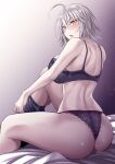  1girl absurdres ahoge ass bangs bare_arms bare_shoulders bed_sheet black_legwear blush bra fate/grand_order fate_(series) from_behind gradient gradient_background hair_between_eyes highres ijima_yuu jeanne_d&#039;arc_(alter)_(fate) jeanne_d&#039;arc_(fate)_(all) knee_up looking_at_viewer looking_back open_mouth panties purple_background purple_bra purple_panties short_hair silver_hair sitting solo thighs underwear yellow_eyes 