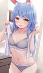  1girl absurdres animal_ear_fluff animal_ears blue_hair blush breasts cleavage clothes_writing collarbone commentary_request cowboy_shot grey_panties grey_sports_bra hands_up highres hololive indoors long_hair looking_at_viewer medium_breasts navel open_mouth orange_eyes panties rabbit-shaped_pupils rabbit_ears smile solo sports_bra sports_panties standing stomach sweatdrop symbol-shaped_pupils towel towel_around_neck typho underwear underwear_only underwear_writing usada_pekora virtual_youtuber 