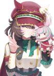  1girl animal_ears blush bow breasts brown_hair cape closed_mouth commentary_request ear_covers ears_through_headwear green_bow hair_between_eyes hand_puppet hat highres horse_ears horse_girl jacket long_sleeves looking_at_viewer marche_lorraine_(racing)_(umamusume) marche_lorraine_(umamusume) mismatched_ear_covers puppet purple_eyes red_cape short_hair simple_background smile solo umamusume v white_background white_jacket yato_kamo 