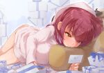 1girl bangs bathrobe berotore blush box breasts card closed_mouth full_body gift gift_box heterochromia highres holding holding_card hololive houshou_marine large_breasts long_hair looking_at_object lying on_stomach red_eyes red_hair smile solo twisted_torso virtual_youtuber white_day yellow_eyes 