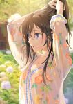  1girl black_hair blouse blurry blurry_background floral_print hair_tie hands_in_hair highres ice_(ice_aptx) long_hair mouth_hold original outdoors purple_eyes solo 