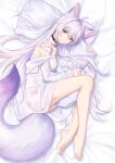  1girl absurdres animal_ear_fluff animal_ears antenna_hair bangs bare_legs bare_shoulders barefoot bed_sheet bell breasts closed_mouth collar commentary_request extra_ears feet fox_ears fox_girl fox_tail from_above full_body highres jingle_bell kirby_d_a large_tail legs long_hair long_sleeves looking_at_viewer lying medium_breasts neck_bell off_shoulder on_bed on_side original pillow pillow_hug purple_eyes purple_hair revision shirt smile tail very_long_hair white_shirt 
