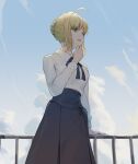  1girl ahoge artoria_pendragon_(all) bangs blonde_hair blue_ribbon blue_skirt braid breasts cotta_(heleif) cowboy_shot day fate/stay_night fate_(series) from_below green_eyes hand_on_own_chin hand_up highres long_sleeves looking_at_viewer outdoors ribbon saber shirt short_hair skirt solo teeth white_shirt 