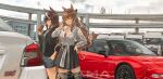  2girls animal_ears asama_(drift_in) black_skirt blurry breasts brown_hair can car cleavage cloud cloudy_sky day depth_of_field green_eyes ground_vehicle highres holding holding_can honda_nsx horse_ears jacket large_breasts long_hair maruzensky_(umamusume) motor_vehicle multiple_girls outdoors shorts skirt sky subaru_impreza symboli_rudolf_(umamusume) thighhighs truck umamusume very_long_hair 