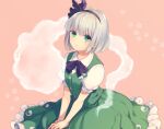  1girl bangs between_legs black_bow black_hairband black_neckwear bob_cut bow bowtie closed_mouth collared_shirt commentary_request eyebrows_visible_through_hair floral_print frills green_eyes green_skirt green_vest hairband hand_between_legs konpaku_youmu konpaku_youmu_(ghost) looking_at_viewer looking_up petticoat pink_background puffy_short_sleeves puffy_sleeves shirt short_hair short_sleeves silver_hair simple_background sitting skirt skirt_set smile solo tomobe_kinuko touhou vest white_shirt 