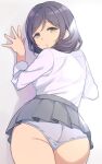  1girl against_wall ass deyuuku eyebrows_visible_through_hair from_behind green_eyes grey_skirt looking_at_viewer looking_back love_live! love_live!_school_idol_project panties pleated_skirt purple_hair skirt solo toujou_nozomi underwear white_panties 