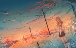  1girl abisswalker8 absurdres bare_legs barefoot cloud commentary gradient_sky highres huge_filesize looking_at_viewer medium_hair original power_lines red_clouds scenery short_sleeves skirt sky splashing sun sunset transformer twisted_torso uniform utility_pole water waves 