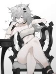 1girl animal_ears arknights bandeau bangs bare_legs bare_shoulders black_choker black_nails breasts chair choker cleavage commentary crossed_legs fataaa feet_out_of_frame grey_background grey_eyes grin hair_between_eyes hair_ornament hairclip hand_up highres lappland_(arknights) long_hair looking_at_viewer midriff nail_polish scar scar_across_eye silver_hair sitting small_breasts smile solo strapless thighs tubetop wolf_ears 
