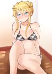  1girl animal_print artoria_pendragon_(all) artoria_pendragon_(lancer)_(fate) bangs bare_arms bare_shoulders bikini blonde_hair blue_eyes blush breasts closed_mouth collarbone commentary_request cow_print eyebrows_visible_through_hair fate/grand_order fate_(series) feet_out_of_frame hair_between_eyes headpiece highres i.u.y large_breasts long_hair looking_at_viewer navel print_bikini side-tie_bikini sidelocks sitting solo swimsuit 