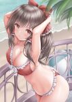  1girl :o akino_irori arms_behind_head arms_up bangs beach bikini blurry blurry_background blurry_foreground blush bow breasts brown_hair cleavage collarbone commentary_request cowboy_shot depth_of_field eyebrows_visible_through_hair frilled_bow frilled_hair_tubes frills from_above hair_bow hair_tubes hakurei_reimu highres large_breasts long_hair looking_at_viewer navel parted_lips railing red_bikini red_bow red_eyes solo standing swimsuit tide touhou water 