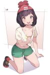  1girl :d arm_support arrow_(symbol) bangs beanie blush breasts clothes_pull collarbone commentary_request eyelashes full_body green_shorts hat highres kneeling medium_hair milky_tea navel no_bra number open_mouth pokemon pokemon_(game) pokemon_sm pulled_by_self red_headwear selene_(pokemon) shirt shirt_pull shoes short_shorts short_sleeves shorts smile solo sweat tied_shirt tongue upper_teeth yellow_shirt 