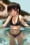  1girl absurdres bare_arms bare_shoulders bikini black_bikini black_hair blurry blurry_background blush bow breasts cleavage closed_mouth depth_of_field green_bow hair_bow highres looking_at_viewer matsunaga_kouyou medium_breasts nose_blush original partially_submerged ponytail ripples smile solo standing swimsuit water 