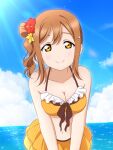  1girl bangs beach bikini breasts brown_hair cleavage flower hair_flower hair_ornament hairclip highres kunikida_hanamaru leaning_forward looking_at_viewer love_live! love_live!_sunshine!! medium_breasts medium_hair shiratama_(siratama_ll) side_ponytail smile standing swimsuit watermark yellow_bikini yellow_eyes 