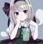  1girl bangs black_hairband black_neckwear black_ribbon blue_background blue_eyes blunt_bangs blush breasts buttons chair closed_mouth cup drink drinking_straw eyebrows_visible_through_hair green_vest hair_ribbon hairband hand_on_own_cheek hand_on_own_face head_tilt highres hitodama ice ice_cube konpaku_youmu konpaku_youmu_(ghost) light_frown looking_at_viewer ribbon riino_(konamonndaisuki) short_hair silver_hair simple_background small_breasts solo table touhou upper_body vest wing_collar 