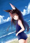  1girl alternate_costume animal_ears azur_lane bangs beach black_hair blue_sky blue_swimsuit blunt_bangs blurry breasts cloud cloudy_sky commentary_request contemporary depth_of_field eyebrows_visible_through_hair fox_ears from_behind horizon long_hair looking_at_viewer looking_back m_ko_(maxft2) nagato_(azur_lane) ocean old_school_swimsuit parted_lips school_swimsuit sidelocks sky small_breasts solo swimsuit twisted_torso yellow_eyes 