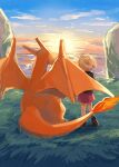  1girl blonde_hair boots brown_footwear charizard cloud day dress fire flame from_behind gen_1_pokemon grass highres jacket mo~zu outdoors pokemon pokemon_(creature) purple_dress shiny shiny_hair short_hair sky standing sunset symbol_commentary 