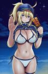  1girl ahoge artoria_pendragon_(all) baseball_cap beach bikini blonde_hair blue_eyes blue_headwear blue_jacket breasts chewing cleavage cropped_jacket cyclone eating fate/grand_order fate_(series) food hand_up hat highres holding holding_food jacket large_breasts looking_at_viewer medium_hair mysterious_heroine_xx_(fate) navel night outdoors ponytail solo swimsuit thigh_strap white_bikini wristband 