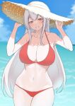  1girl absurdres adjusting_clothes adjusting_headwear beach bikini breasts cleavage collarbone hat highres kantai_collection large_breasts long_hair looking_at_viewer navel ocean outdoors red_bikini red_eyes shoukaku_(kancolle) sidelocks silver_hair skindentation solo standing sun_hat swimsuit takaman_(gaffe) 