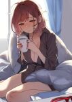  1girl 92m ahoge backlighting bed_sheet blush breasts brown_eyes brown_hair brown_nails brown_shirt cleavage collarbone cup curtains drink eyebrows_visible_through_hair eyewear_removed half-closed_eyes highres holding holding_cup holding_drink large_breasts medium_hair nail_polish on_bed open_clothes open_shirt original pillow quilt shirt sitting solo steam wariza window 
