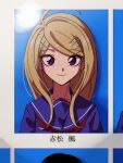  1girl ahoge akamatsu_kaede alternate_costume bangs blonde_hair blue_background blue_eyes blue_sailor_collar blue_shirt blush closed_mouth commentary_request danganronpa_(series) danganronpa_v3:_killing_harmony eighth_note eyebrows_visible_through_hair hair_ornament hairclip highres long_hair looking_at_viewer musical_note neckerchief nzeneee photo_(object) sailor_collar shirt smile solo upper_body white_background 