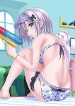  1girl animal ass back barefoot bikini blush bow breasts cat floral_print food food_in_mouth hair_bow hair_ornament highres kaga_sumire looking_at_viewer lupinus_virtual_games popsicle sengoku_aky short_hair silver_hair sitting solo swimsuit visor_cap water_gun 