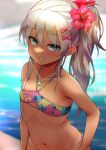 1girl aqua_eyes bangs bikini bikini_bottom_pull bikini_tan blurry blurry_background blush bow commentary flat_chest flower grecale_(kancolle) grin groin hair_between_eyes hair_bow hibiscus highres jewelry kantai_collection looking_at_viewer multicolored multicolored_bikini multicolored_clothes necklace out-of-frame_censoring pink_bow platinum_blonde_hair ponytail pulled_by_self rampage_2nd red_flower side_ponytail sidelocks smile smug solo sparkle swimsuit tan tanlines water wet 