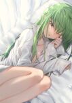  1girl bed_sheet breasts c.c. cleavage code_geass commentary_request creayus eyebrows_visible_through_hair green_hair legs long_hair long_sleeves looking_at_viewer lying naked_shirt on_side one_eye_closed open_clothes open_shirt pillow shirt small_breasts solo white_shirt yellow_eyes 