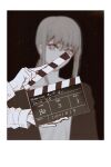  1girl 1other blurry blurry_background border chainsaw_man clapperboard depth_of_field head_out_of_frame head_tilt highres holding hoshi_san_3 long_hair looking_at_viewer low_ponytail makima_(chainsaw_man) ponytail white_border 