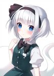  1girl alternate_hairstyle bangs black_bow black_hairband black_neckwear blue_eyes blush bow bowtie buttons closed_mouth collar commentary_request eyebrows_visible_through_hair eyes_visible_through_hair ghost green_skirt green_vest hairband hand_up highres konpaku_youmu konpaku_youmu_(ghost) looking_at_viewer myon_(phrase) puffy_short_sleeves puffy_sleeves shirt short_sleeves short_twintails silver_hair simple_background skirt solo suzuno_naru touhou twintails vest white_background white_collar white_shirt white_sleeves 