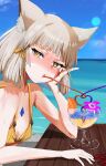  1girl beach bikini blush chest_jewel commentary_request cup drinking_straw eyelashes grey_hair highres nia_(xenoblade) outdoors shindayomon short_hair solo_focus swimsuit table upper_body xenoblade_chronicles_(series) xenoblade_chronicles_2 yellow_bikini yellow_eyes 