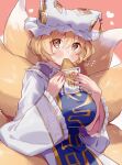  1girl absurdres blonde_hair blush breasts eating eyebrows_visible_through_hair food fox_tail hair_between_eyes highres holding holding_food large_breasts long_hair looking_at_viewer masanaga_(tsukasa) red_background short_hair solo tabard tail touhou yakumo_ran yellow_eyes 